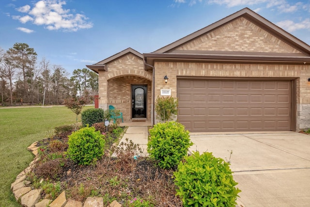 view of front of house with a garage, a front yard, concrete driveway, and brick siding