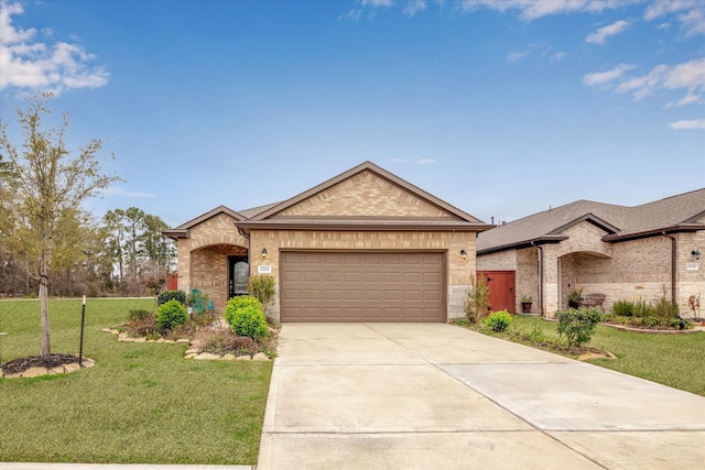 view of front facade with a garage, a front yard, brick siding, and driveway