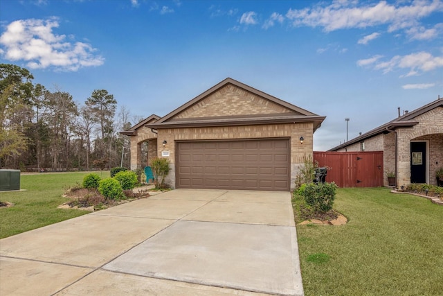 view of front of house featuring a front yard, brick siding, driveway, and an attached garage