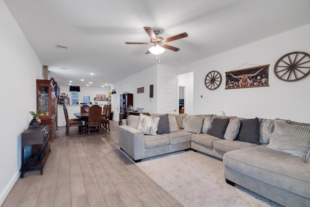 living room featuring light wood-style flooring, visible vents, ceiling fan, and recessed lighting