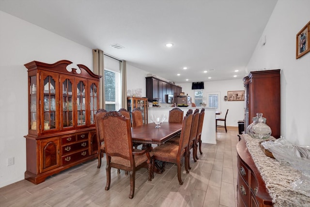 dining space with recessed lighting, visible vents, baseboards, and wood finish floors