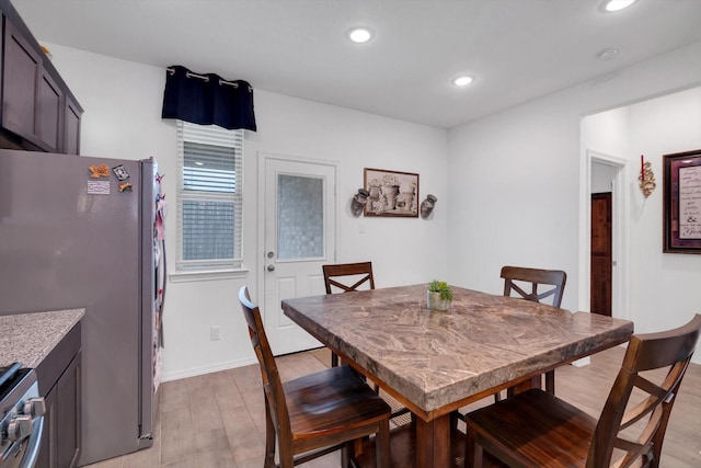 dining space with light wood-style floors, recessed lighting, and baseboards