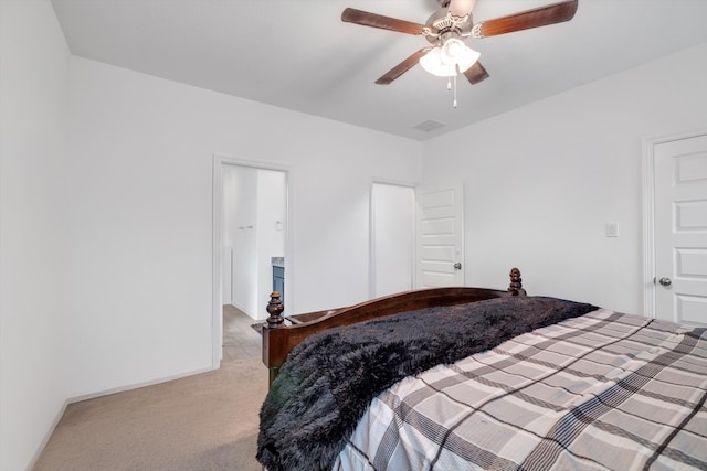 carpeted bedroom with ceiling fan and baseboards