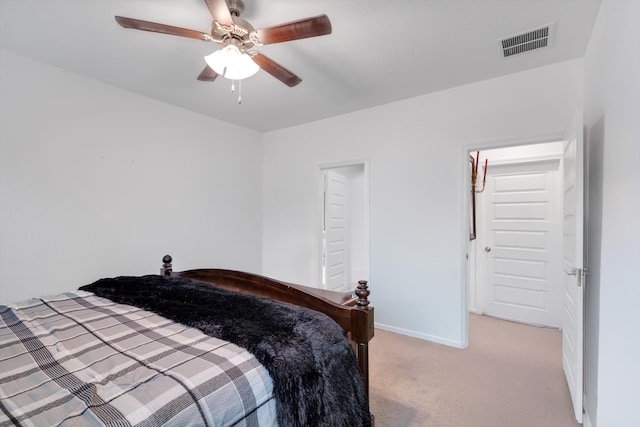 bedroom with light carpet, ceiling fan, visible vents, and baseboards