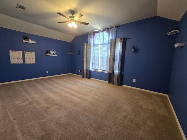 4731 Mohegan Ct, Baytown, TX 77521 - empty room featuring ceiling fan, visible vents, baseboards, lofted ceiling, and carpet
