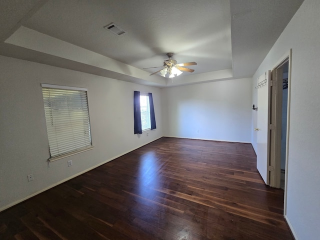 4731 Mohegan Ct, Baytown, TX 77521 - unfurnished room with a ceiling fan, visible vents, wood finished floors, baseboards, and a tray ceiling