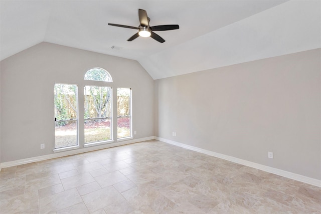 unfurnished room featuring visible vents, vaulted ceiling, and baseboards