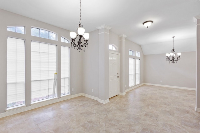 unfurnished room featuring a wealth of natural light, a notable chandelier, and ornate columns