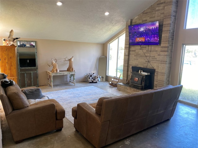 living room with concrete flooring, lofted ceiling, and a textured ceiling