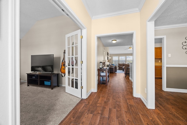 hallway with baseboards, ornamental molding, dark wood finished floors, and a textured ceiling