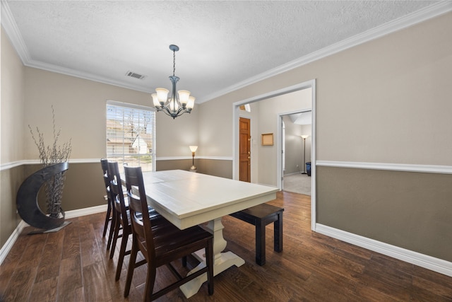 dining area with baseboards, visible vents, dark wood finished floors, crown molding, and a notable chandelier