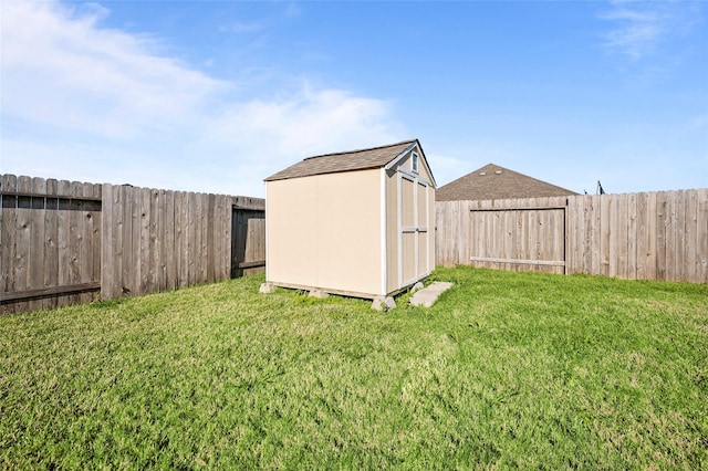 view of yard with an outbuilding, a storage shed, and a fenced backyard