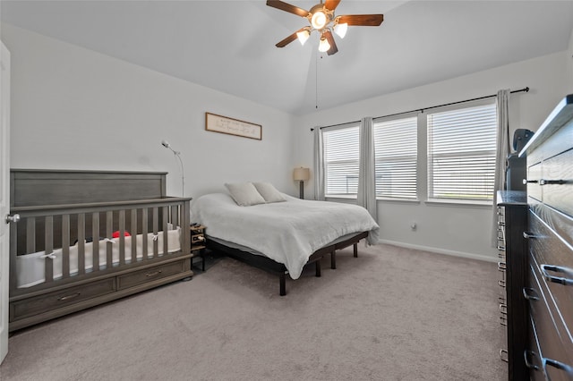 bedroom with vaulted ceiling, ceiling fan, carpet flooring, and baseboards