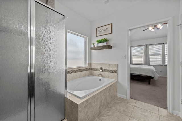 bathroom with a stall shower, tile patterned flooring, a garden tub, and ensuite bath