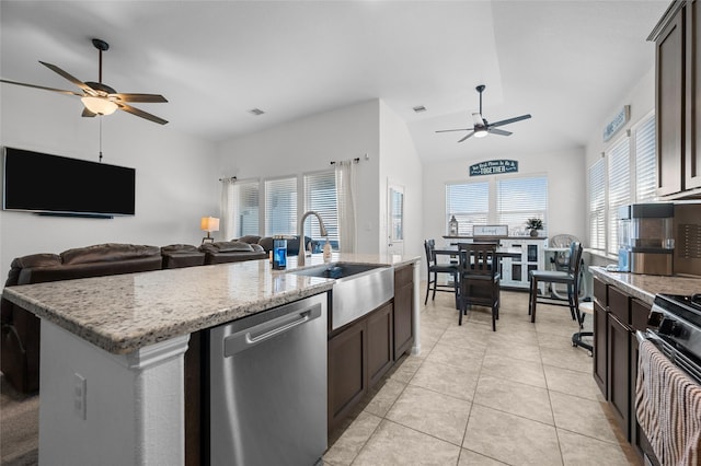 kitchen with light tile patterned flooring, a sink, dark brown cabinets, dishwasher, and an island with sink