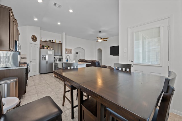 dining space featuring arched walkways, light tile patterned floors, recessed lighting, visible vents, and a ceiling fan