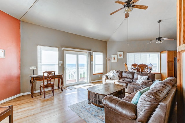 living area featuring light wood-style floors, plenty of natural light, and baseboards