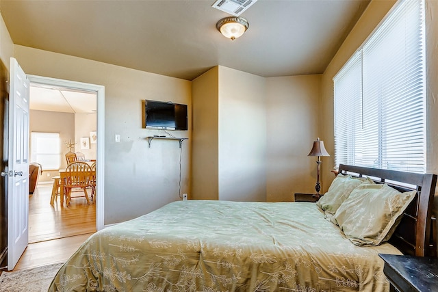 bedroom with wood finished floors and visible vents