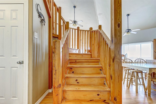 stairway featuring ceiling fan and wood finished floors