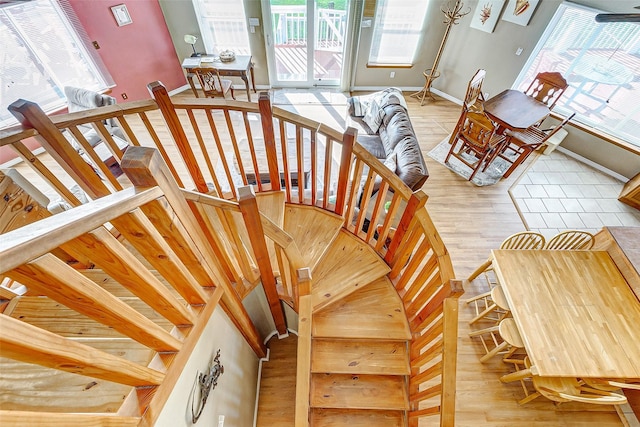 stairway featuring baseboards and wood finished floors