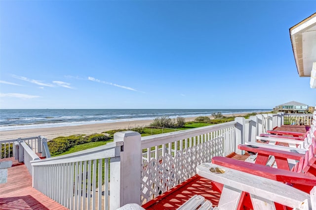 balcony featuring a deck with water view and a view of the beach