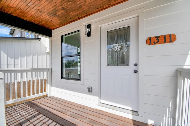 view of exterior entry featuring covered porch