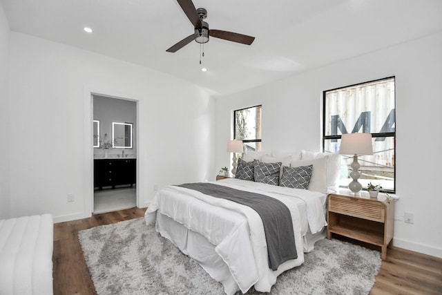 bedroom featuring connected bathroom, recessed lighting, wood finished floors, a ceiling fan, and baseboards