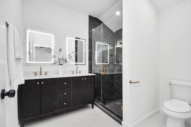 bathroom with a sink, a shower stall, toilet, and double vanity