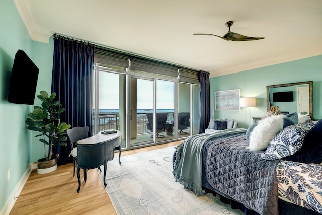 bedroom featuring crown molding, ceiling fan, baseboards, wood finished floors, and access to outside