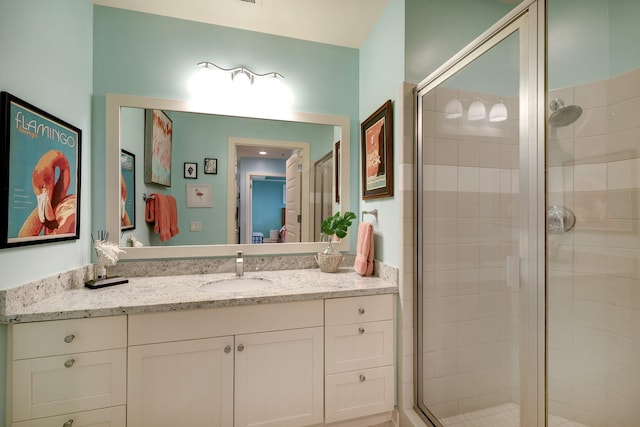 bathroom featuring a stall shower and vanity