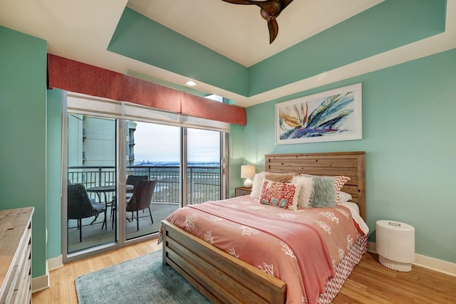 bedroom with baseboards, light wood-style floors, and access to exterior