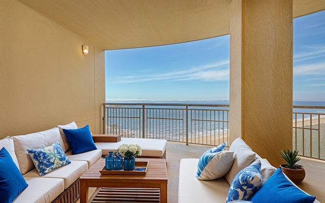 balcony featuring an outdoor hangout area and a water view