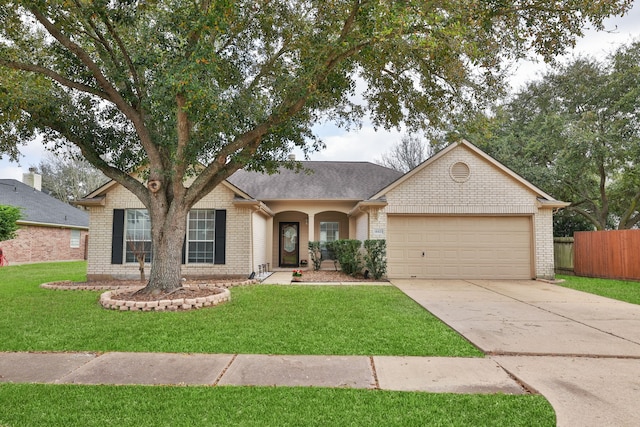 ranch-style home featuring concrete driveway, fence, brick siding, and a front lawn