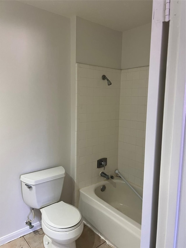 full bath featuring tile patterned floors, toilet, baseboards, and shower / bathtub combination