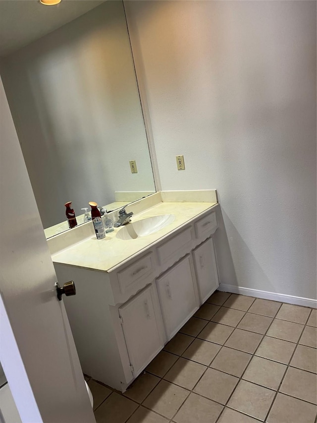 bathroom featuring tile patterned flooring, vanity, and baseboards