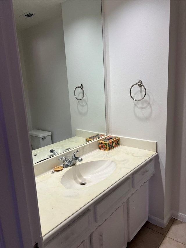 half bath featuring visible vents, baseboards, toilet, tile patterned floors, and vanity