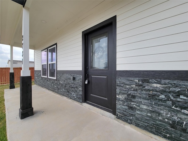 doorway to property with fence