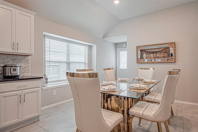 dining room with light tile patterned floors, baseboards, recessed lighting, and vaulted ceiling