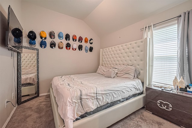 carpeted bedroom featuring baseboards and lofted ceiling