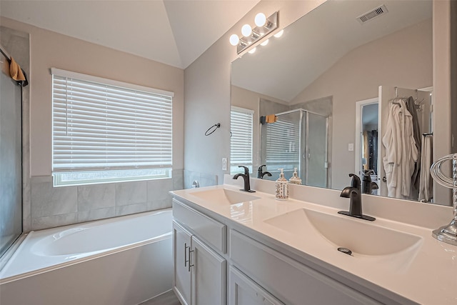 full bath featuring lofted ceiling, a healthy amount of sunlight, and a sink