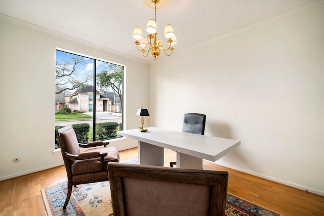 office area with an inviting chandelier, a wealth of natural light, crown molding, and light wood finished floors