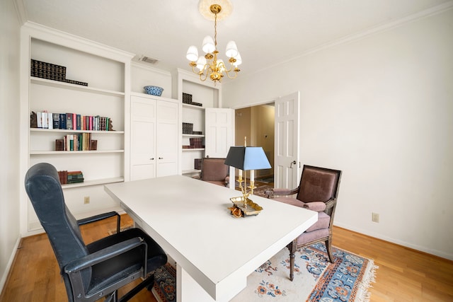 home office featuring light wood-type flooring, visible vents, crown molding, baseboards, and a chandelier