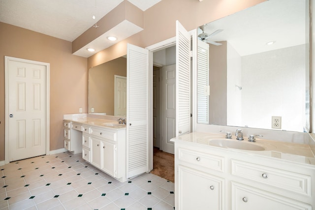 bathroom featuring a sink, two vanities, ceiling fan, and tile patterned flooring