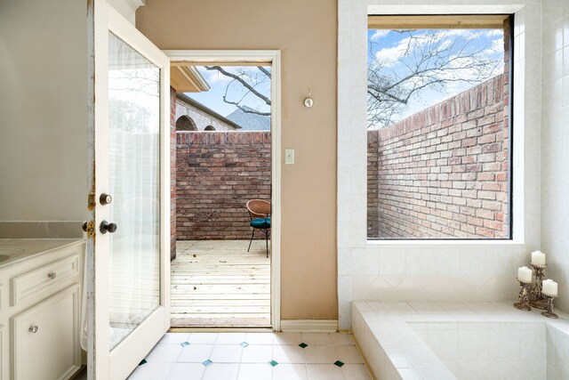 12215 Clearfork Dr, Houston, TX 77077 - bathroom with brick wall, vanity, and baseboards