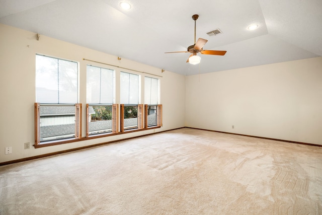 carpeted empty room featuring visible vents, lofted ceiling, recessed lighting, baseboards, and ceiling fan