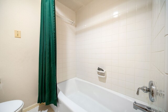 12215 Clearfork Dr, Houston, TX 77077 - bathroom with shower / bath combo, toilet, baseboards, and tile patterned flooring