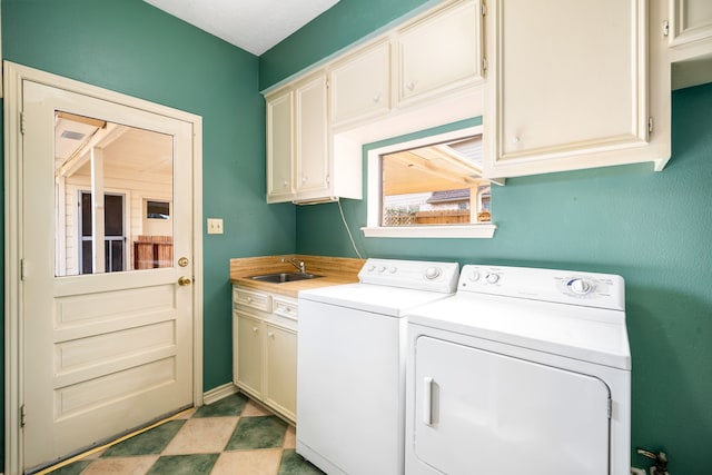 laundry area featuring a sink, cabinet space, and washing machine and clothes dryer