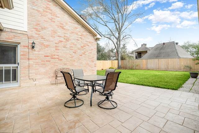 view of patio featuring outdoor dining area and fence private yard