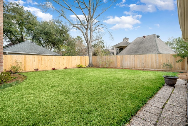 view of yard with a fenced backyard