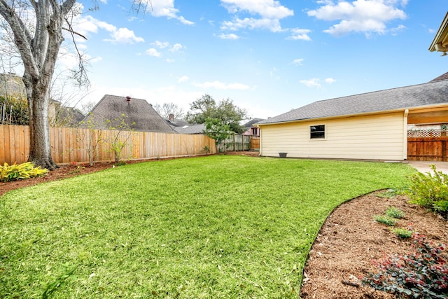 view of yard with a fenced backyard